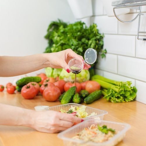a-woman-pours-soy-sauce-into-a-salad-vegetables-a-2022-08-01-05-00-00-utc-min.jpg Fitness Programs - The Best Nutrition